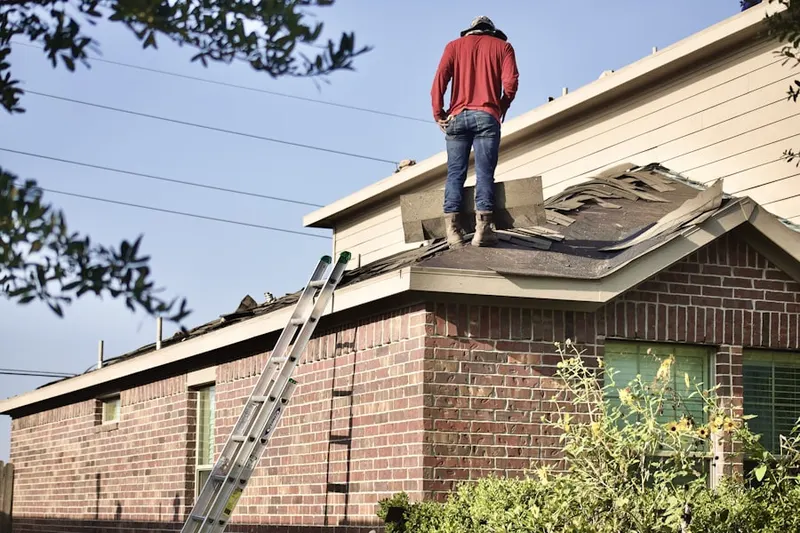 Professional roofer working on a residential roof in Oceanville